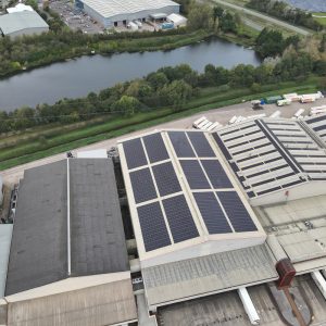 Aerial view of a large Iceland warehouse featuring Ortus Energy rooftop solar panels, showcasing sustainable energy solutions.