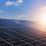 Bright and sunny rooftop solar panels harnessing renewable energy under clear blue skies.