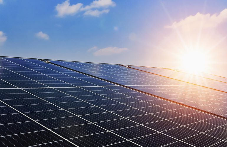 Bright and sunny rooftop solar panels harnessing renewable energy under clear blue skies.
